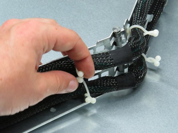 Untether the cable from the chassis by untwisting the six nylon cable management ties.
