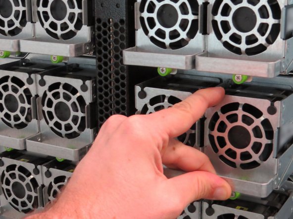 Push the fan towards the chassis.