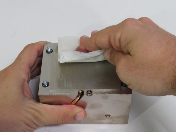 Scrape parallel to the machined grain, as shown.