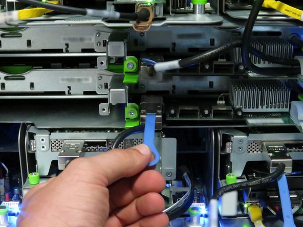 Disconnect the Mini-SAS cable from the storage tray.