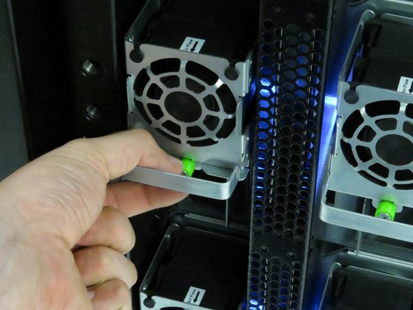 Unscrew the thumbscrew on each of the fans.