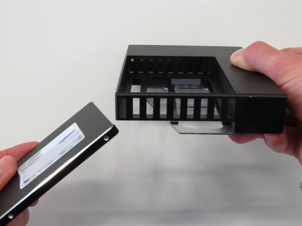 Remove the SSD from the adapter, as shown.