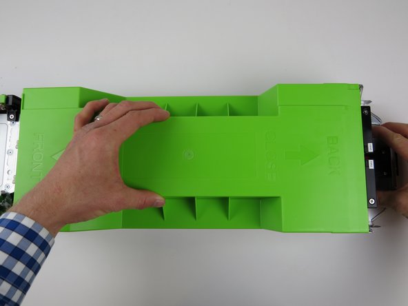 Slide it towards the rear of the chassis until it clicks into place and resistance is felt.