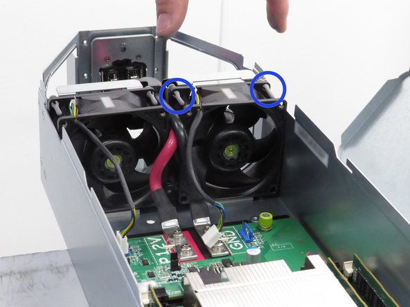 Grasp the fan as shown and lift it away from the server chassis.