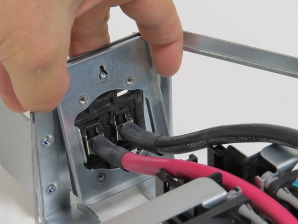 Pull the bus lead retention bracket upwards until resistance is felt.