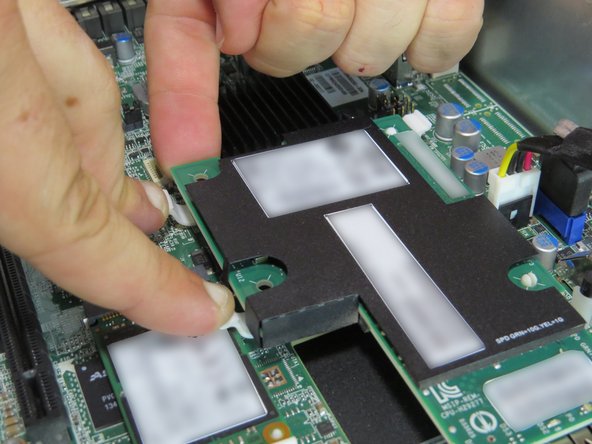 Gently push the rear corners of the NIC upwards.