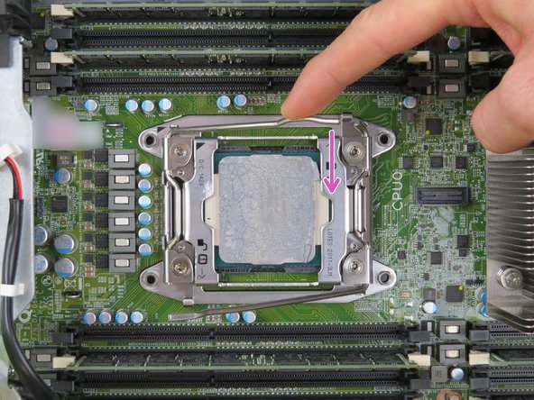 Unlatch the 'lock' retention lock second, by simultaneously pushing down and inward on the lever as shown.