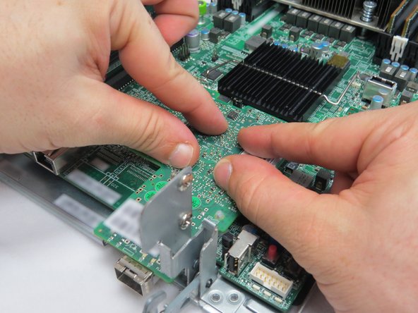 Place the NIC on the four nylon risers.