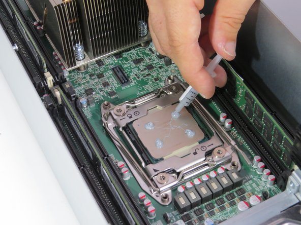 Apply thermal compound to the top of the CPU using the 5-dot method.