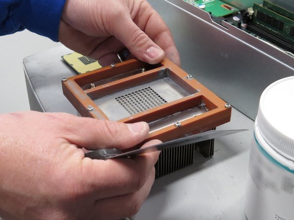 Seat the stencil on the bottom of the heatsink (as shown).