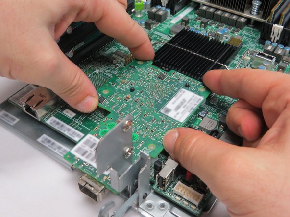 Place the NIC on the four nylon risers.