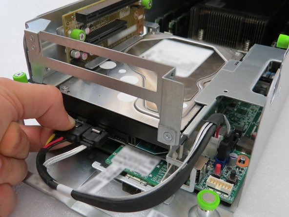 Press the metal retention tab to release the cable.