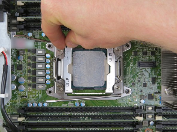 Lift the CPU retention bracket.Allow the CPU retention bracket to pivot, and let stand vertically.