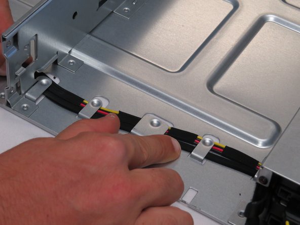 Position the SATA / power cable in the chassis cable guide, as shown.