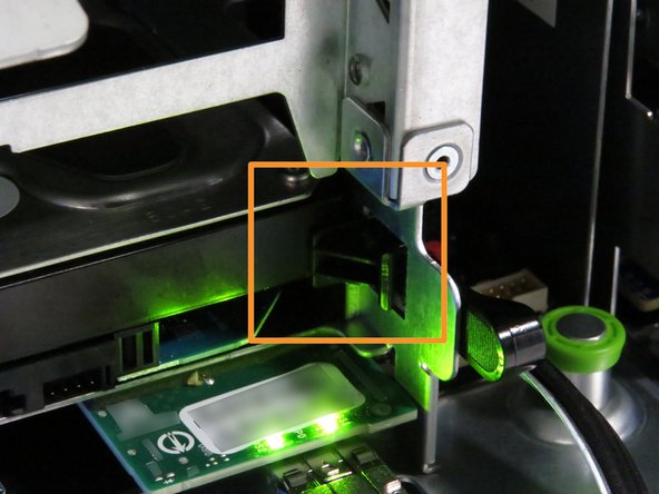 Ensure the black nylon HDD release has secured the drive, as shown.