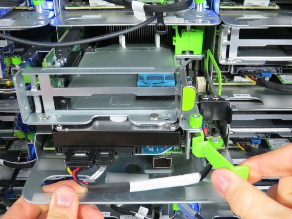 While holding the lever to the right, simultaneously pull it outward to release the HDD from it's socket.