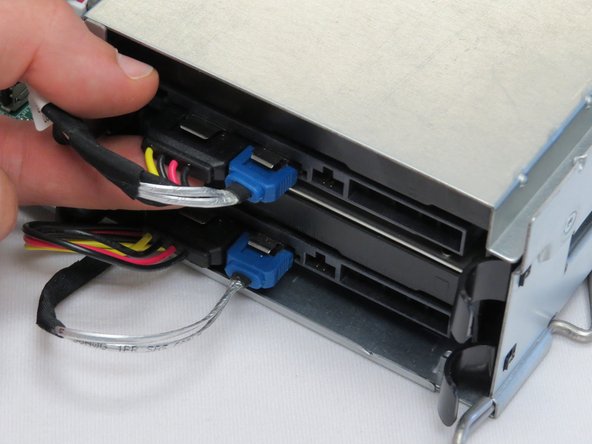 The images in this procedure displays HDD removal on a work surface. However, servicing a HDD can be accomplished in-rack.