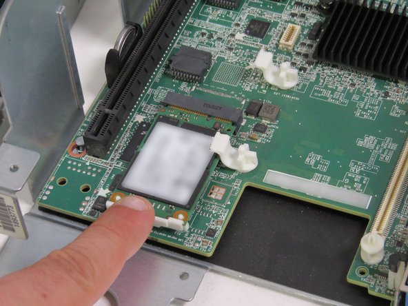 Engage the mSATA drive and drive clip, as shown.