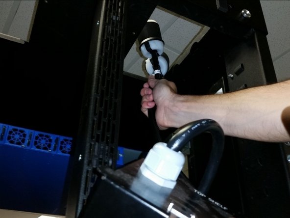 From inside the rack, send the 3-phase AC input plugs that connect to the tap box through the PDU opening from inside the rack to outside the rack so the plug lies on the rack roof or dangles along the side of the rack.