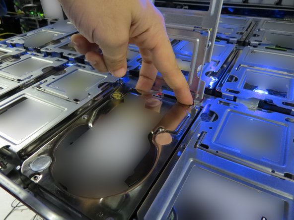 Lightly push the HDD away from its connector.