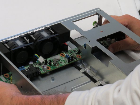 Pull the midplane board through the cutout located on the right side of the chassis, as shown.