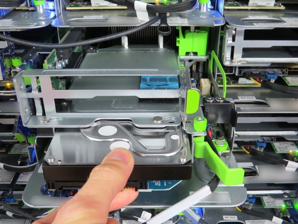 Place your fingers on each side of the HDD to remove it the rest of the way.