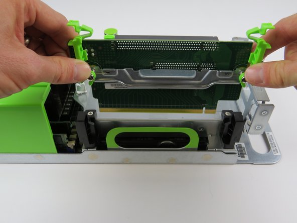 Grasp the PCI riser card, as shown and lift the card from its socket to remove.