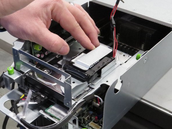 Remove the RAID controller and its tethered battery pack, as shown.