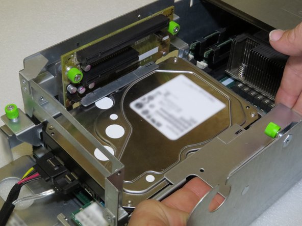 Grasp the right side of the riser cage, as shown.