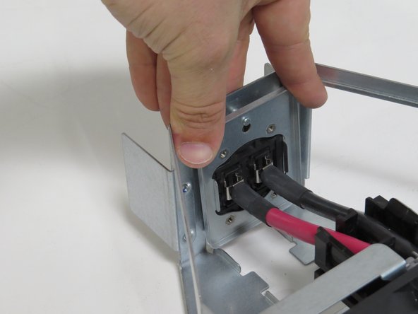 Press the bus lead retention bracket down until resistance is felt.