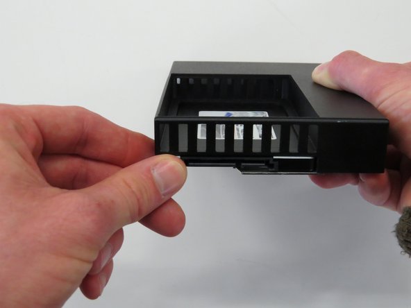 Insert a new SSD into the adapter, as shown.