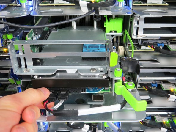 Disconnect the following cables by pressing down on the metal retention tabs pulling away from the HDD.