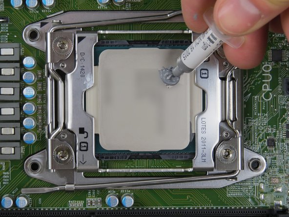 Apply thermal compound to the top of the CPU using the 5-dot method.