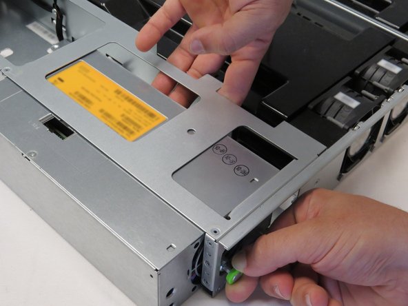 Push the PSU away from the chassis while holding the plunger outwards, as shown.