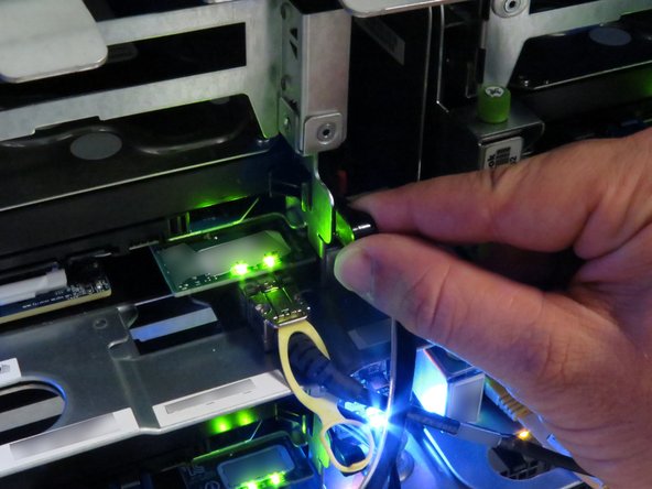 Pull the black nylon HDD release lever towards the right of the server.