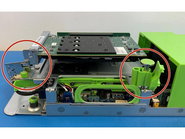 Locate the green retention plunger at the right side of the AVA assembly, next to the large green chassis cover.
