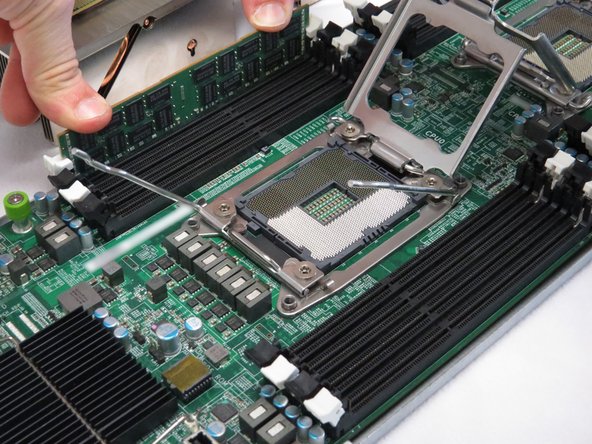 Press the DIMM down into the slot until the retention tabs spring upward to secure the module.