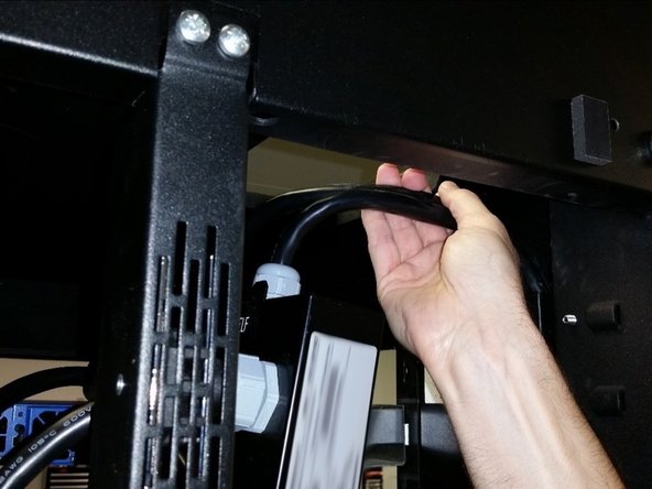Slowly pull the AC cables out of the trough from the top of the rack.