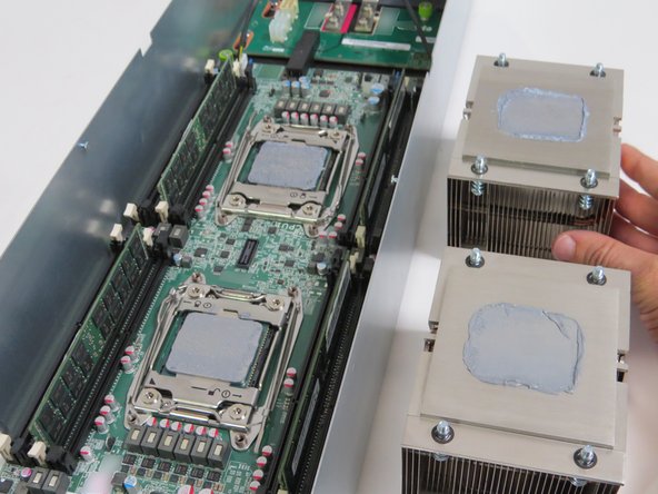 Place each heatsink next to their respective CPU socket.