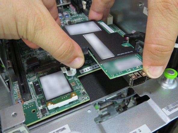 Lift and remove the NIC.