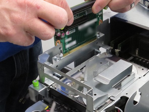 Lift the riser card away from its socket.