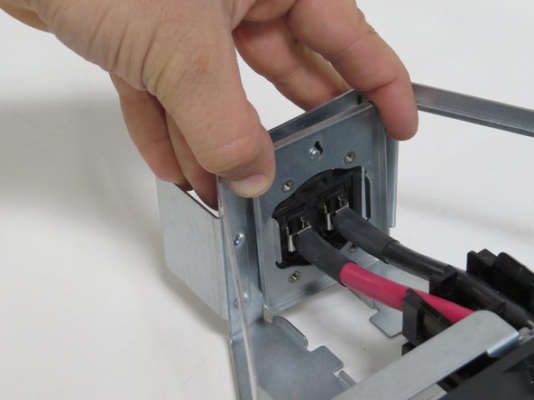 Position the bus lead retention bracket, as shown.