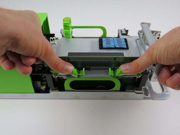 A 'click' will be felt when the PCI riser card retention levers have secured the card.