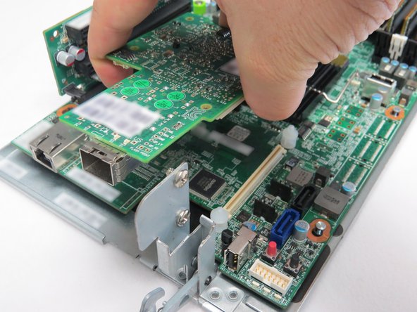 Lift the NIC away from the server motherboard.