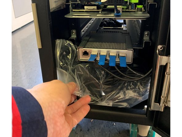 Remove 2 plastic bags containing power cables and quick start guide indicated by circles