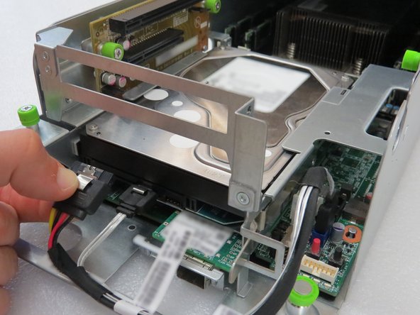 Press the metal retention tab to release the cable.