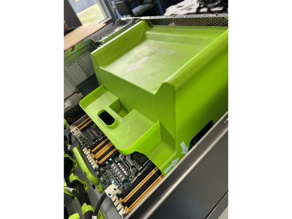 Remove the green air flow baffle by pulling it towards the rear of the unit and then lifting up.