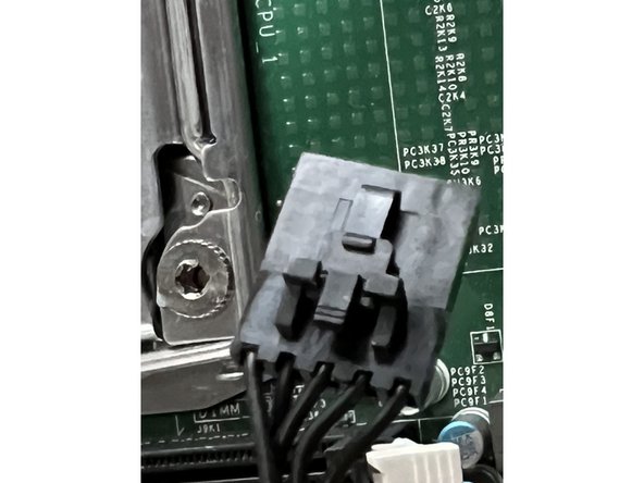 Remove the smaller black connector.  It too has a small locking clasp.  Depress the clasp and pull the connector housing straight up.