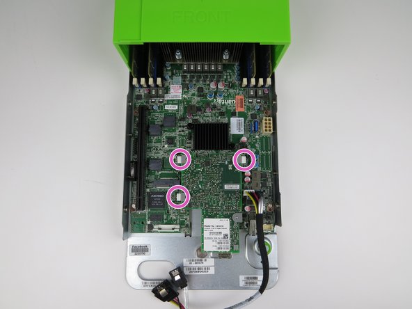 Locate the (3) retention tabs which secure the NIC to the (4) motherboard standoffs.