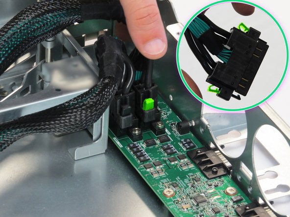 Pinch the two retention tabs on the Powerblade cable, as shown.